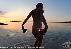 nude fire dancer seduces on beach at sunset