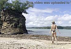 Pretty Babe Cleans Natural Beach at Pacific Ocean.