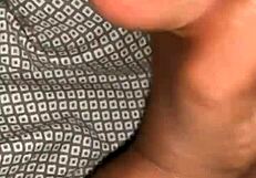 A husband gives his wife a handjob leading to a cumshot in their bedroom.