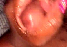 A husband gives his wife a handjob leading to a cumshot in their bedroom.