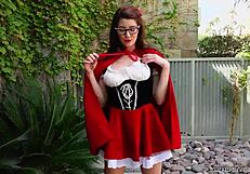 Amber Hahn in little red costume plays solo outdoors