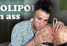 Tattooed brunette plays with candy in ass to mouth