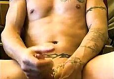 Sexy southern man with intricate tattoos on his arms and chest