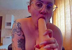 Big tits babe sucks sex toy and gives footjob with dildo