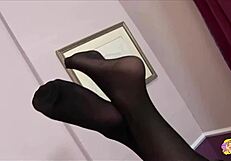 A blonde woman in red stockings relaxes while a brunette friend assists with a soothing session involving gentle touches and care