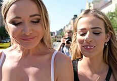 two blondes, ria sunn and venera maxima, share a casual kiss in the kitchen