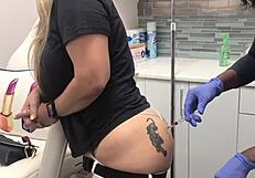 Blonde client with butt tattoo receives injection during spa massage session 2, watched voyeuristically