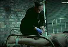 Dominatrix Mistress April torments slave on special prison bed with electro shocks.