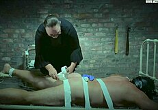 Dominatrix Mistress April torments slave on special prison bed with electro shocks.