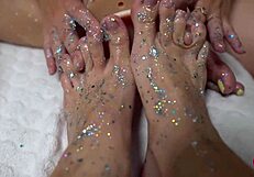 Two Cuties With Shiny Legs Tease With a Huge Rubber Cock in Footjob Play