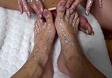 Two Cuties With Shiny Legs Tease With a Huge Rubber Cock in Footjob Play