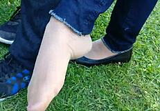 Enjoying shoeplay and dipping in tan nylons with flats