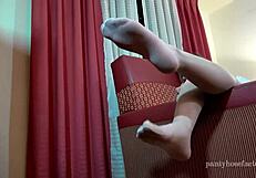 Mika teases with silk pantyhose on feet