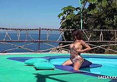 Tattooed latina getting freaky by the pool