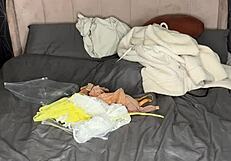 Blonde tries on lingerie at home in homemade video.