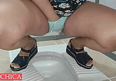 Hot sexy girl pees in panties at public toilet