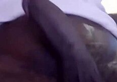 Young African man intensely masturbates, focusing on every stroke and sensation