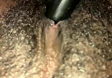 This ebony girl is playing with her hairy pussy