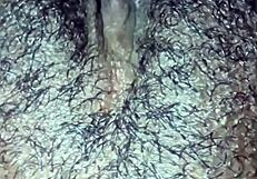 This ebony girl is playing with her hairy pussy