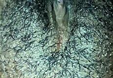 This ebony girl is playing with her hairy pussy