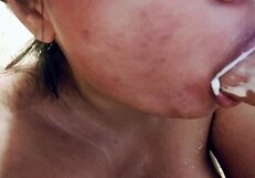 Sucking on big realistic messy milk dildo closeup