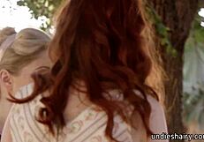 Blonde licks redhead's pussy outdoors