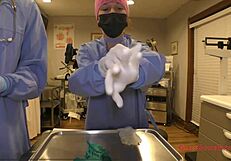 Tanned brunette Jewel with short hair and small tits tries gloves in hospital backstage