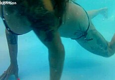 Melissa the mermaid swims in pool with tattoos