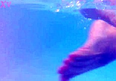 Melissa the mermaid swims in pool with tattoos