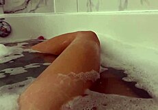 Petite brunette moans during orgasm in shower
