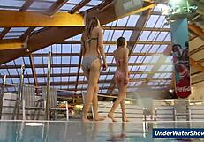 Horny girls strip each other in the pool, ripping clothes