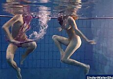 Horny girls strip each other in the pool, ripping clothes