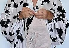 Busty granny Mariaolds shows off natural tits in stockings.