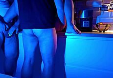 wife indulges in neon-lit threesome sucking two cocks