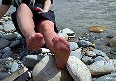 goddess teases with tan nylon soles and toes by the riverside, close-up fetish delight