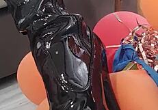 Veve performs balloon popping in latex stockings with a sharp