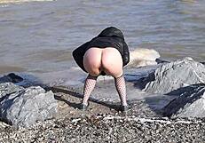 Watch This Milf Pissing In The Sea With Her Hairy Pussy!