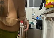 Young woman does live in kitchen, showing swollen pussy