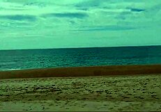 Guy on nude beach spills a lot of milk