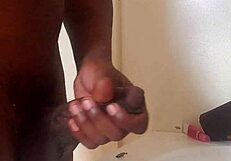 a big black cock gets stroked until it cums