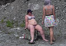 A lesbian washes her friend's pussy outdoors then licks to orgasm