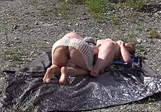 A lesbian washes her friend's pussy outdoors then licks to orgasm