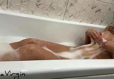 in the bathroom, a brunette milf masturbates passionately under the shower, reaching orgasm with wet pussy