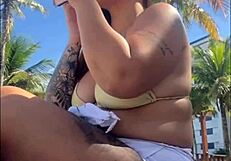 African woman feels excitement flashing on beach