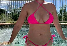 Wife flashes her big tits in the hotel pool for exhibitionist fun.