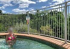 Wife flashes her big tits in the hotel pool for exhibitionist fun.