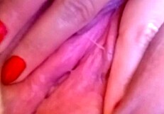 feeling the wetness of her pink pussy while masturbating