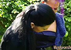 two women enjoy golden shower and toys in outdoor setting