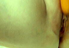 Amateur housewife passionately fucks her pussy with a big fat carrot in homemade video.