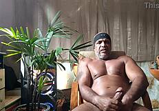pornstar brasil brazilian bear kojac indulges in solo masturbation, stroking his huge hairy cock
